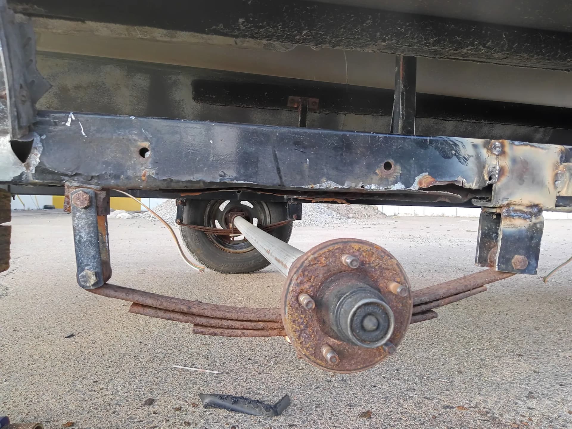 Trailer frame and axle exposed during structural welding repair