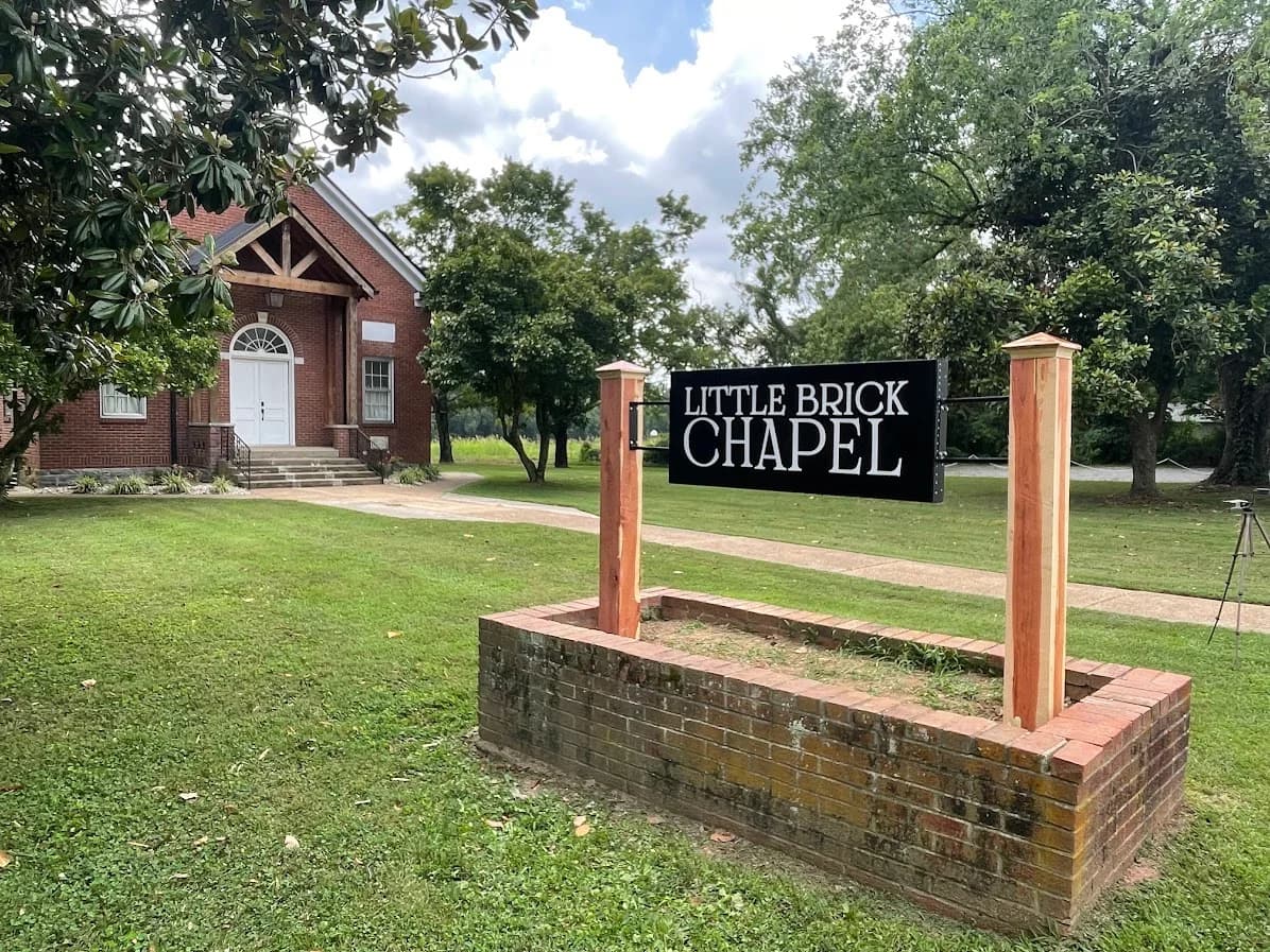Custom-made metal signage installed on a brick church